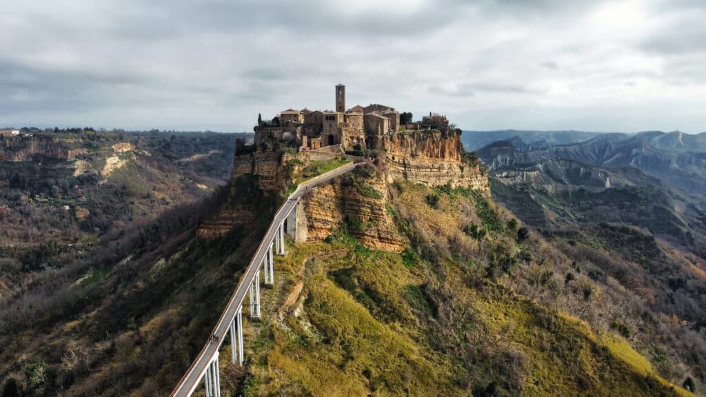 Civita di Bagnoregio, a picturesque Italian hilltop town connected by a narrow bridge, illustrating the potential for sustainable tourism in iconic destinations.