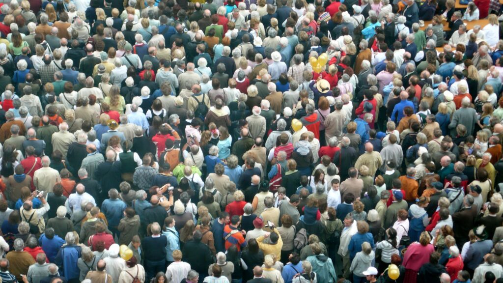 Crowded tourists overwhelming an iconic destination, highlighting the impact of mass tourism and the need for sustainable travel solutions