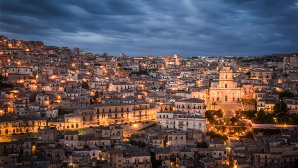 Night view of Modica's illuminated streets and San Giorgio Cathedral in Sicily