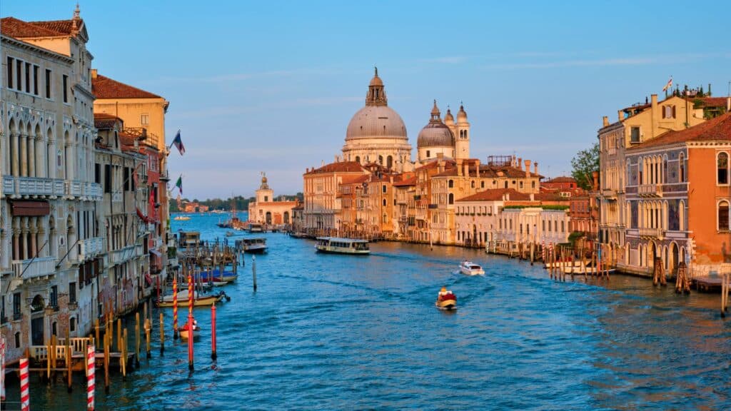 View of the Grand Canal in Venice with the Basilica di Santa Maria della Salute at sunset.