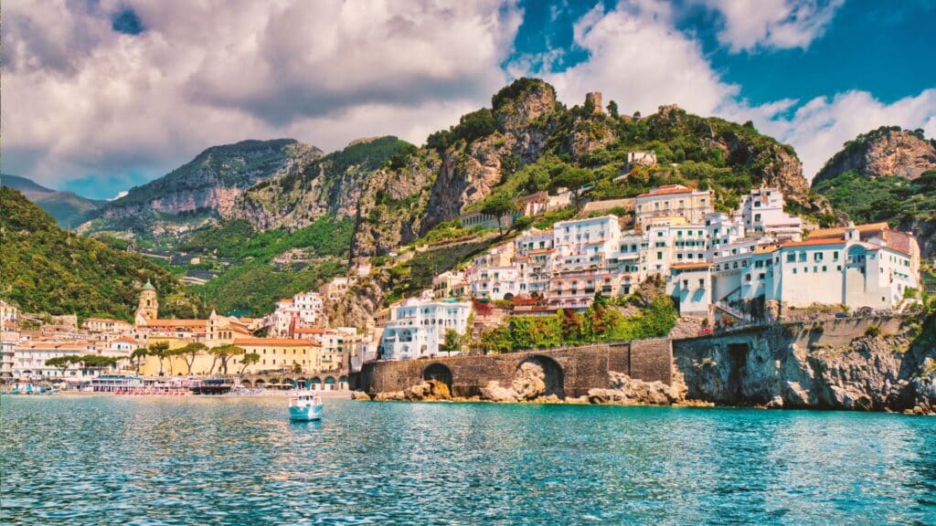 Stunning summer view of the Amalfi Coast from the sea, showcasing its vibrant beauty. Travel to Amalfi Coast, Travel to Napoli, Italian Cuisine.