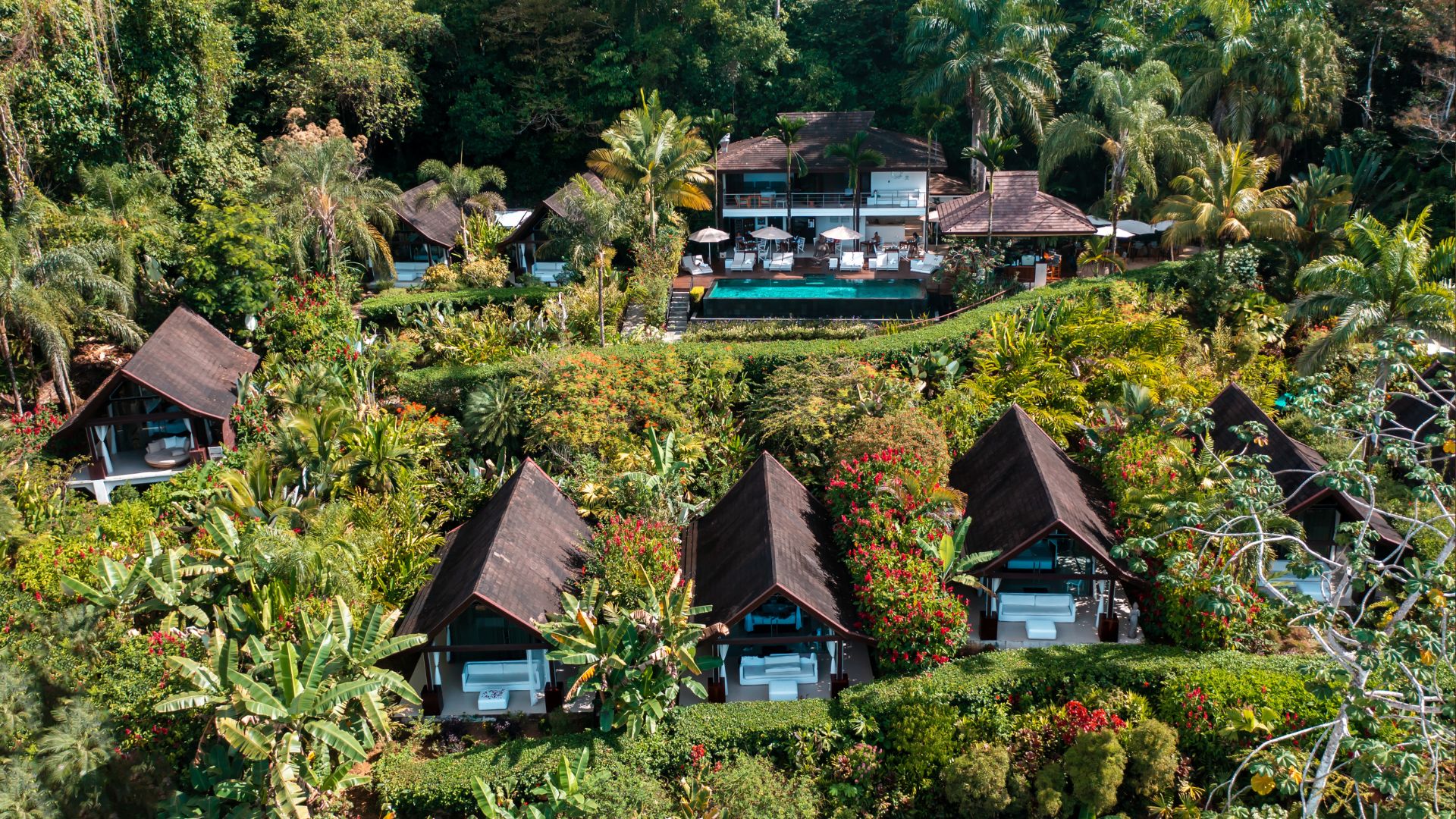 Aerial view of a luxury sustainable accommodation in Costa Rica, showcasing eco-friendly architecture surrounded by lush greenery.