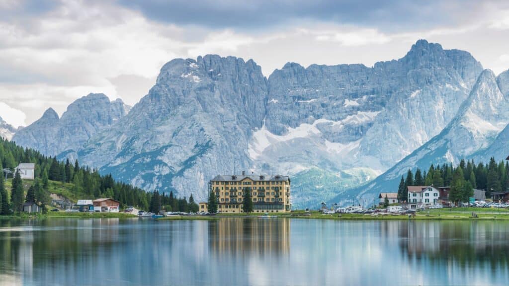 Reflection of mountains in Lago di Misurina, showcasing the stunning scenery for Travel to the Dolomites and Alpine Lakes.