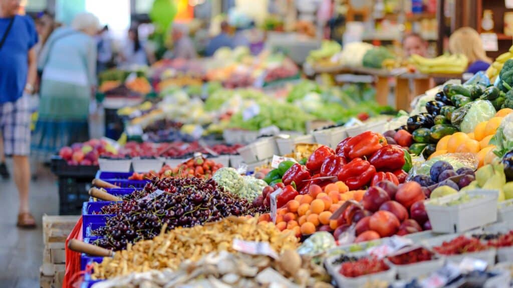 Local farmers' market showcasing fresh vegetables, promoting sustainable travel through mindful food choices and cultural immersion.