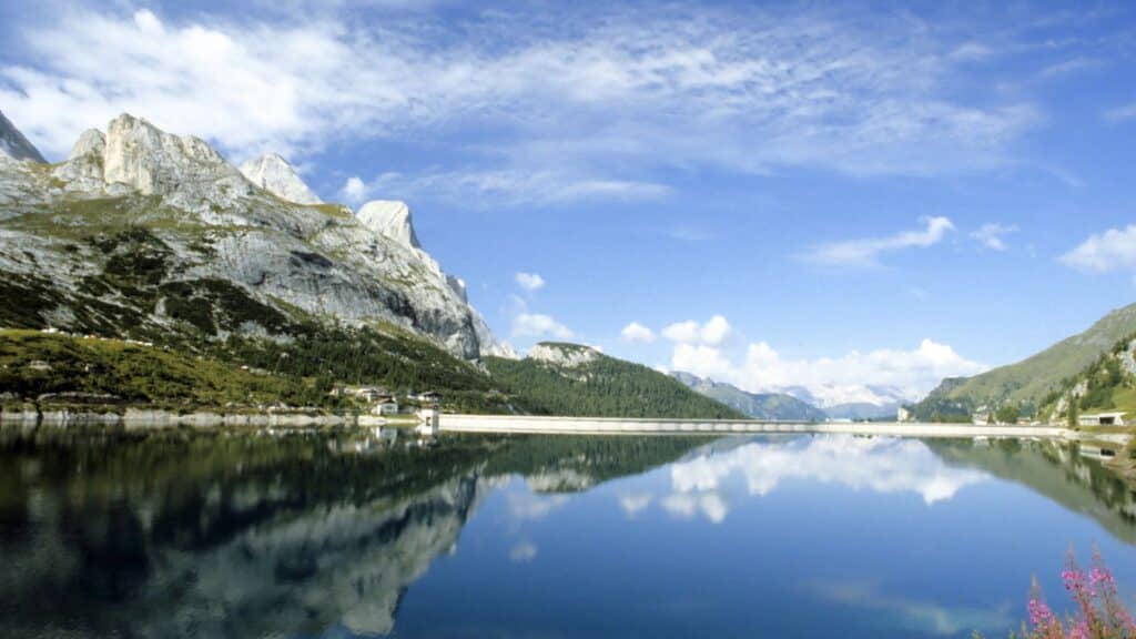 Lago di Fedaia in summer with the reflection of Marmolada, showcasing the beauty of Alpine Lakes in the Dolomites.