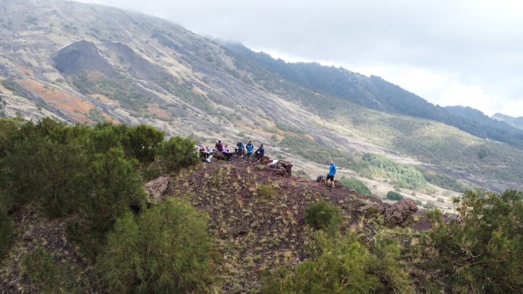 Group of travelers on Mount Etna in Sicily, embracing the Sensorial Travel™ approach.