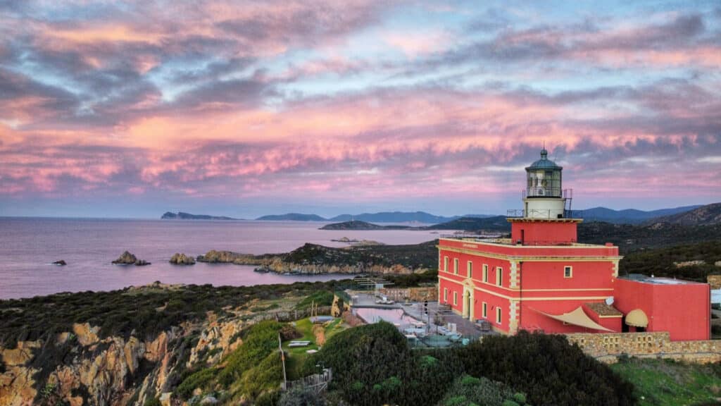 Faro di Capo Spartivento in Sardinia at sunset, representing luxury and authentic Sensorial Travel™ experiences.