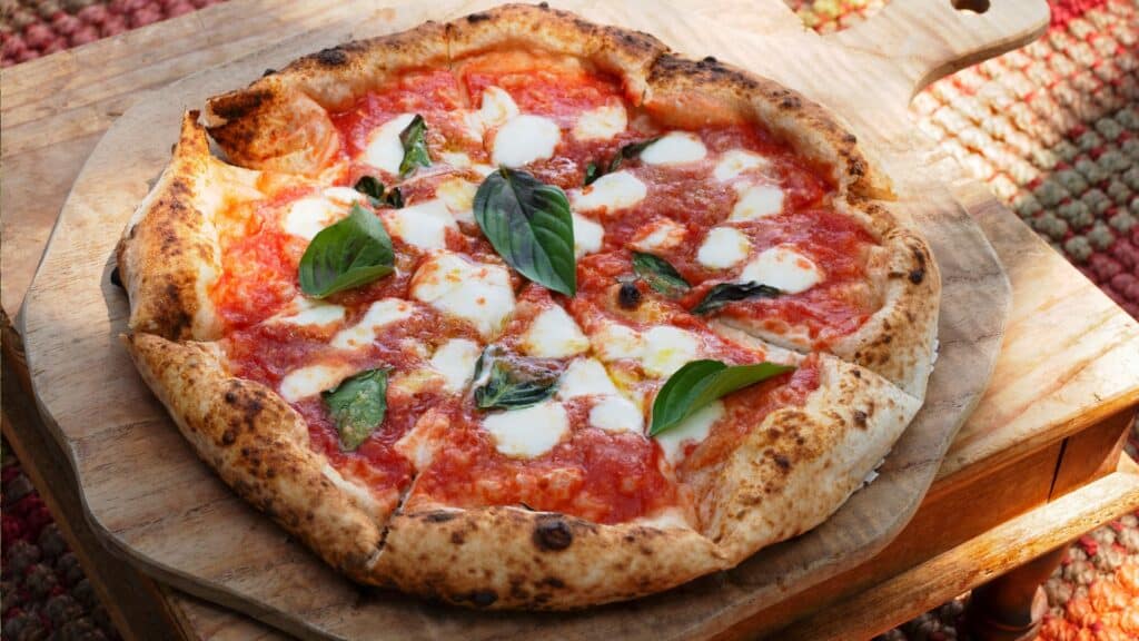 Neapolitan Margherita pizza, an iconic dish of Italian cuisine, perfect for your Travel to Amalfi Coast or Travel to Napoli experience, showcasing the rich flavors of Napoli.