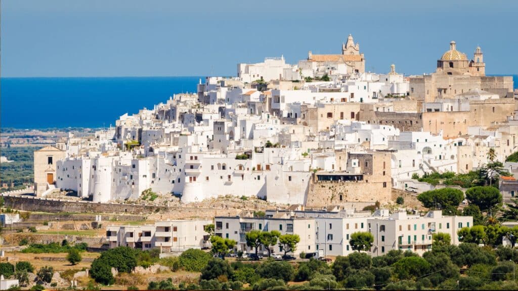 The whitewashed buildings of Ostuni, the "White City," perched on a hilltop with views of the Adriatic Sea.