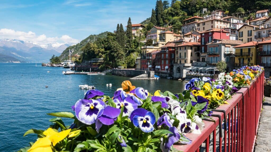 A Serene View Of Lake Como With Picturesque Mountains In The Background, Framed By Vibrant Greenery, Ideal For A Family Vacation To Lake Como And St. Moritz.