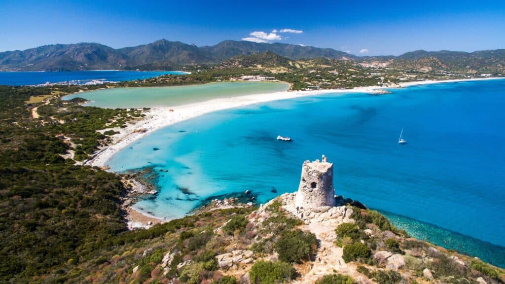 Aerial view of a stunning Sardinian beach with turquoise waters and white sand, capturing the island’s natural beauty and offering the perfect Italian escape.