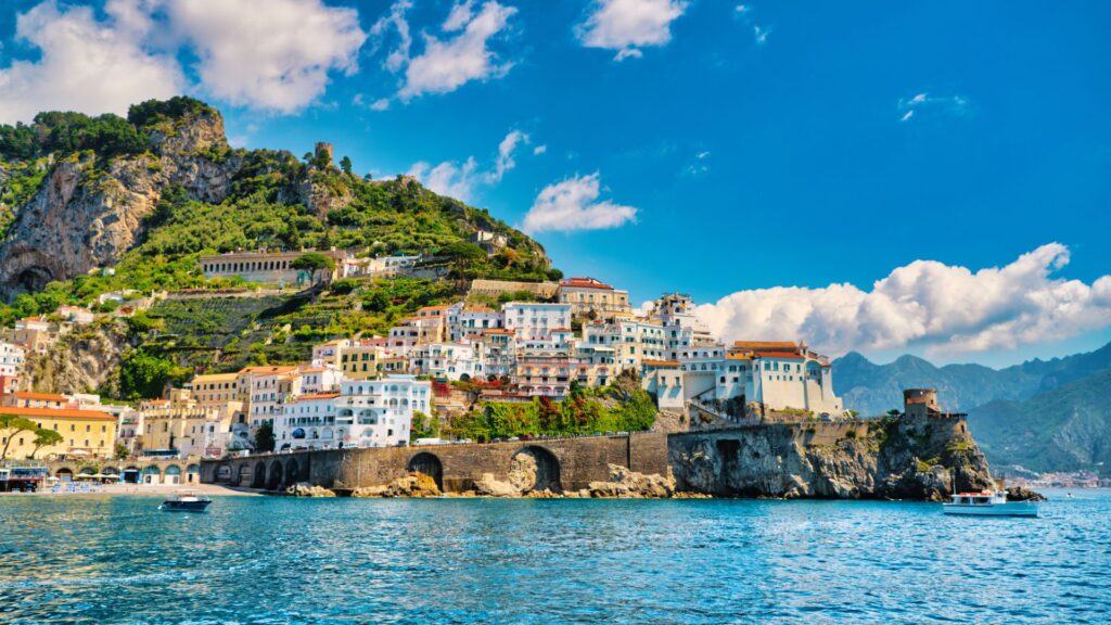 A panoramic view of the Amalfi Coast, with colorful cliffside villages and the Mediterranean Sea.