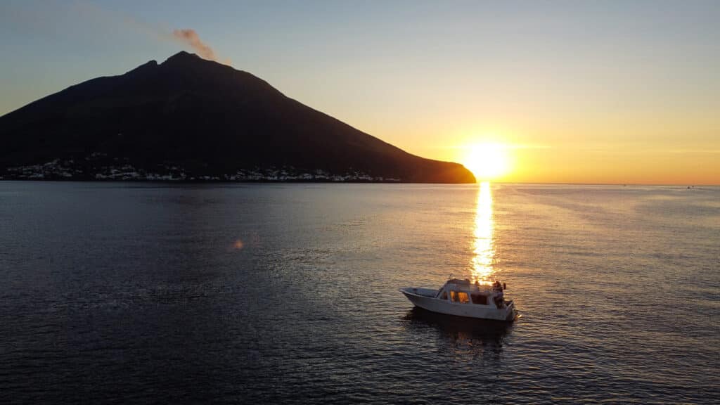 Travelers Enjoying A Boat Experience In The Aeolian Islands With Giuseppe, Overlooking The Stromboli Volcano At Sunset During A Small Group Tour.