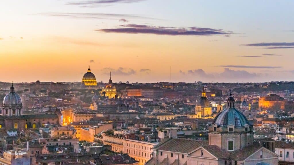 View Of Rome'S Rooftops At Sunset, Showcasing The Beauty Of The Eternal City.